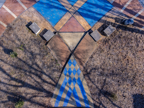 Aerial view of geometric paving stones with blue and brown contrasting patterns create a symmetrical design Maastrichtkwartier Flevoland Netherlands. Aerial view of geometric paving stones with blue and brown contrasting patterns create a symmetrical design Maastrichtkwartier Flevoland Netherlands.