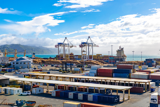 Wellington New Zealand 18 February 2026 View of the bustling port where stacks of colorful shipping containers meet the vast expanse of the turquoise sea.