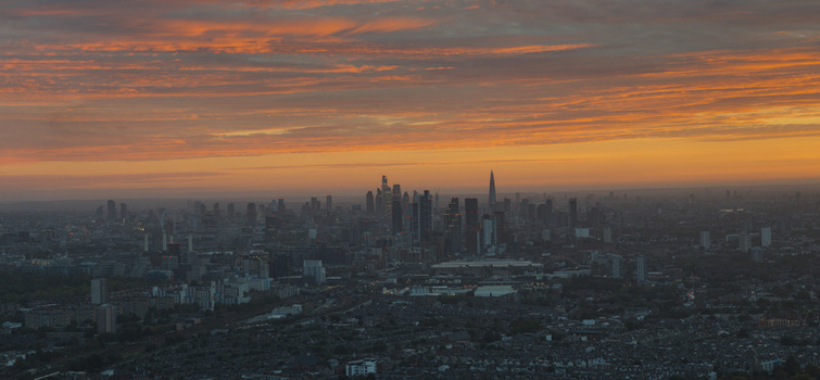 Aerial view of the London skyline at sunset with vibrant orange clouds over the city featuring prominent skyscrapers and urban architecture in Wandsworth London United Kingdom.