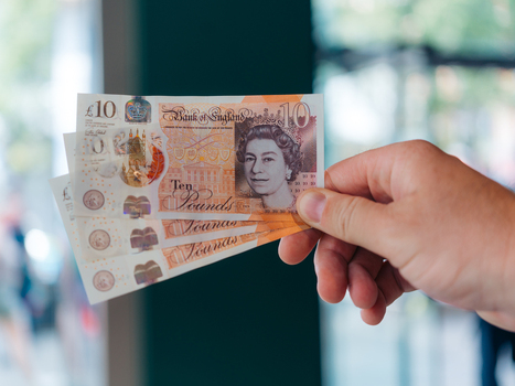 London United Kingdom 20 June 2025 View of a hand holding new ten pound notes the crisp paper reflecting the light a portrait of Queen Elizabeth II gazing out from the currency. London United Kingdom 20 June 2025 View of a hand holding new ten pound notes the crisp paper reflecting the light a portrait of Queen Elizabeth II gazing out from the currency.