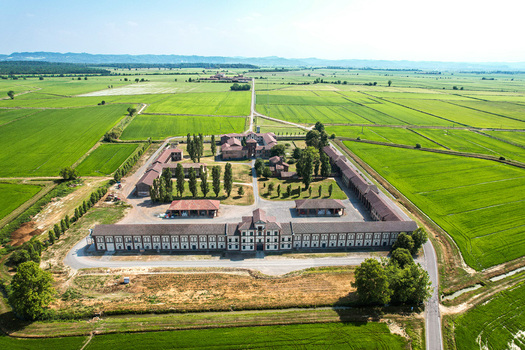 Aerial view of Tenuta Darola a historic estate surrounded by vast green rice fields and agricultural land in Trino Piemonte Italy. Aerial view of Tenuta Darola a historic estate surrounded by vast green rice fields and agricultural land in Trino Piemonte Italy.