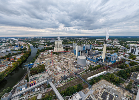 Aerial view of Heizkraftwerk Reuter West a combined heat and power plant undergoing conversion to renewable energy with a cooling tower and river in Berlin Berlin Germany.