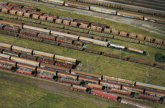 Aerial view of a large railway yard with multiple parallel tracks filled with freight trains cargo cars and graffiti in Saalfeld Thuringia Germany. Aerial view of a large railway yard with multiple parallel tracks filled with freight trains cargo cars and graffiti in Saalfeld Thuringia Germany.