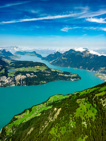 Aerial view of the dazzling turquoise waters of Lake Lucerne winding through verdant hillsides a picturesque scene of natural beauty Lucerne Switzerland. Aerial view of the dazzling turquoise waters of Lake Lucerne winding through verdant hillsides a picturesque scene of natural beauty Lucerne Switzerland.