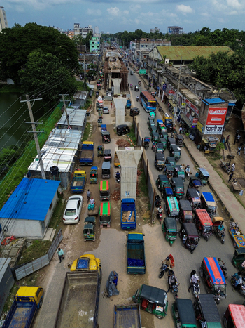 Rajshahi Bangladesh 26 September 2026 Aerial view of a busy street with ongoing bridge construction numerous auto rickshaws trucks and vehicles navigating through the urban area under a cloudy sky. Rajshahi Bangladesh 26 September 2026 Aerial view of a busy street with ongoing bridge construction numerous auto rickshaws trucks and vehicles navigating through the urban area under a cloudy sky.
