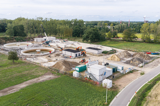 Diepenbeek Flanders Belgium 30 August 2026 Aerial view of a wastewater treatment plant under construction with concrete tanks machinery and earth piles surrounded by green fields. Diepenbeek Flanders Belgium 30 August 2026 Aerial view of a wastewater treatment plant under construction with concrete tanks machinery and earth piles surrounded by green fields.