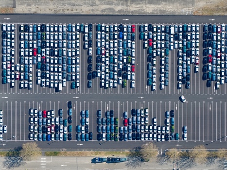 Aerial view of hundreds of cars neatly arranged in a vast parking lot showcasing a symphony of colors and geometric precision Sausheim Grand Est France.