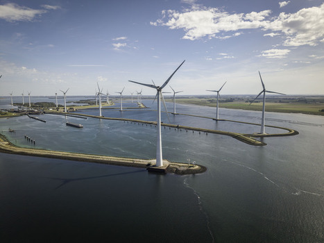 Aerial view of Grevelingendam wind farm with white turbines standing in the water surrounded by calm sea and green coastal landscape in Bruinisse Zeeland Netherlands. Aerial view of Grevelingendam wind farm with white turbines standing in the water surrounded by calm sea and green coastal landscape in Bruinisse Zeeland Netherlands.