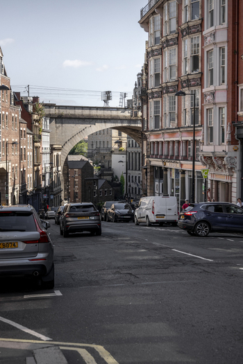 Newcastle upon Tyne United Kingdom 13 July 2026 View of a street in Newcastle upon Tyne with historic brick buildings parked cars and a stone arch bridge in the background. Newcastle upon Tyne United Kingdom 13 July 2026 View of a street in Newcastle upon Tyne with historic brick buildings parked cars and a stone arch bridge in the background.
