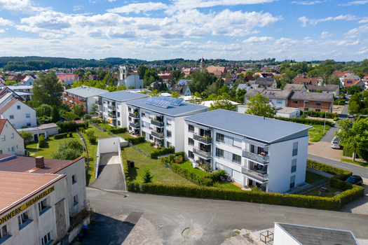 Aerial view of modern residential apartment buildings with solar panels and green gardens in Erlangen Bavaria Germany.