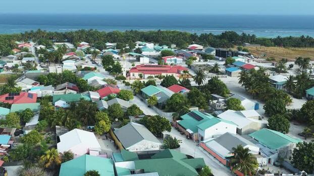 Aerial view of colorful rooftops and palm trees in Maldives. Aerial view of colorful rooftops and palm trees in Maldives.