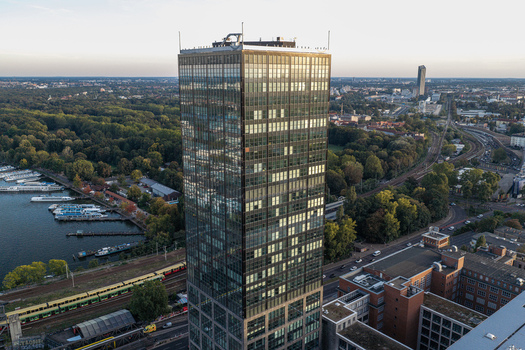 Aerial view of the Berlin Treptowers skyscraper reflecting the sky situated next to the Spree river with railway tracks and urban greenery in Berlin Berlin Germany. Aerial view of the Berlin Treptowers skyscraper reflecting the sky situated next to the Spree river with railway tracks and urban greenery in Berlin Berlin Germany.