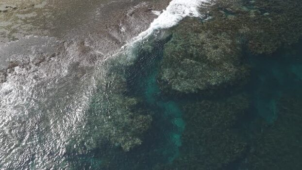 Aerial view of coral reefs and turquoise water in Siargao Philippines.