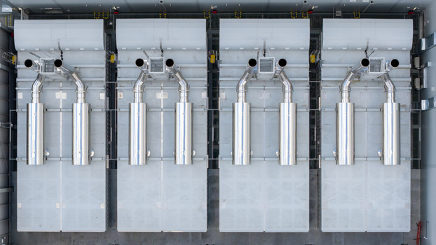 Aerial view of industrial cooling units and exhaust pipes of an AI data center infrastructure in Warsaw Masovian Voivodeship Poland. Aerial view of industrial cooling units and exhaust pipes of an AI data center infrastructure in Warsaw Masovian Voivodeship Poland.