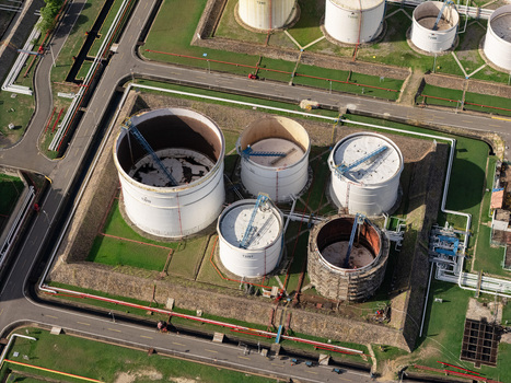 Aerial view of industrial storage tanks and pipelines at an oil refinery in Bajos de Haina San Cristobal Province Dominican Republic.
