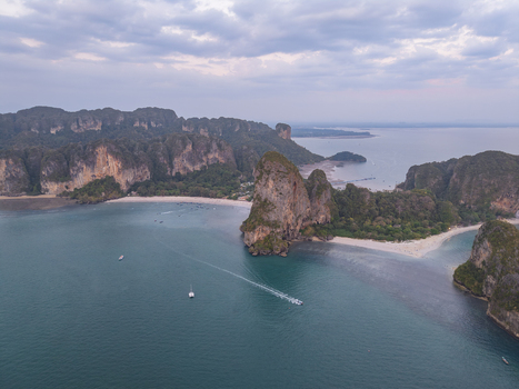 Aerial view of boats sailing through the turquoise waters surrounded by limestone cliffs and sandy beaches Krabi Thailand. Aerial view of boats sailing through the turquoise waters surrounded by limestone cliffs and sandy beaches Krabi Thailand.