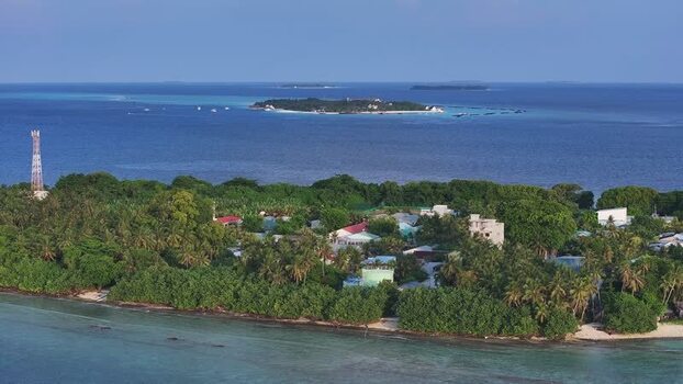 Aerial view of the tropical island of Kamadhoo and turquoise waters Maldives. Aerial view of the tropical island of Kamadhoo and turquoise waters Maldives.