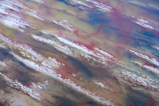 Aerial view of vibrant swirling patterns of pink white blue and beige create an abstract landscape from above Salt Lake City Utah United States. Aerial view of vibrant swirling patterns of pink white blue and beige create an abstract landscape from above Salt Lake City Utah United States.