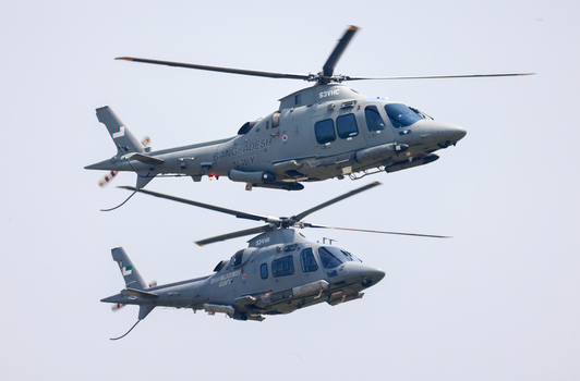 Dhaka Bangladesh 25 March 2026 View of two military helicopters soaring in unison against a clear bright sky their grey bodies a contrast to the blue backdrop.
