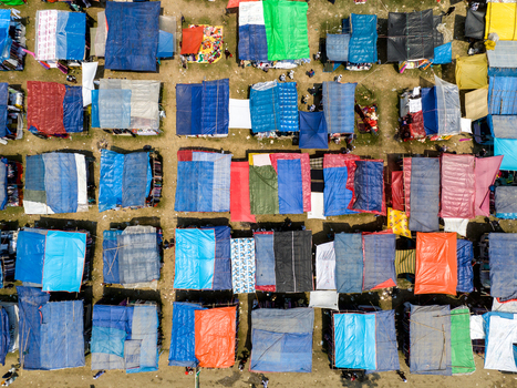 Aerial view of colorful makeshift shelters create a patchwork of textures and tones against the bare earth Charmonai Barisal Division Bangladesh. Aerial view of colorful makeshift shelters create a patchwork of textures and tones against the bare earth Charmonai Barisal Division Bangladesh.