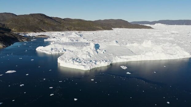Aerial view of Ilulissat glacier and dark blue sea Greenland.