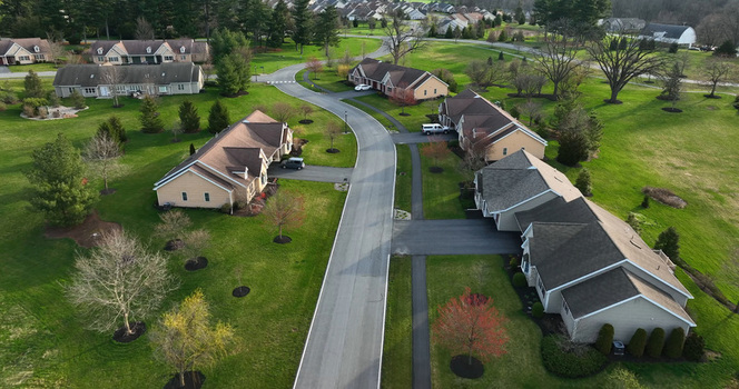 Aerial view of a retirement community campus featuring residential buildings paved roads and green lawns in West Donegal Township Pennsylvania United States.