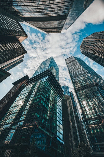 View of towering skyscrapers reaching towards the heavens their glass facades reflecting the azure sky above in Frankfurt Hessen Germany. View of towering skyscrapers reaching towards the heavens their glass facades reflecting the azure sky above in Frankfurt Hessen Germany.