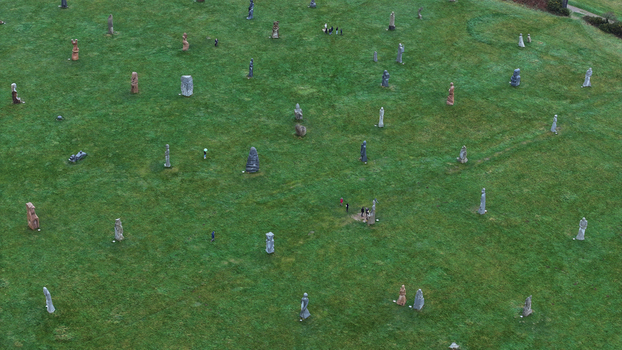 Carnoet France 26 December 2023 Aerial view of Valley of Saints featuring granite statues of Breton saints scattered across a green hillside with visitors walking between them. Carnoet France 26 December 2023 Aerial view of Valley of Saints featuring granite statues of Breton saints scattered across a green hillside with visitors walking between them.