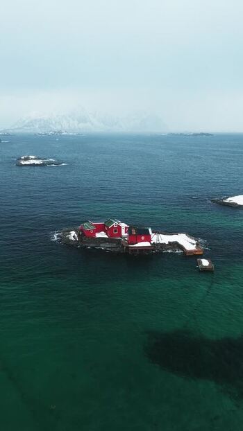 Aerial view of the island with red house Norway.