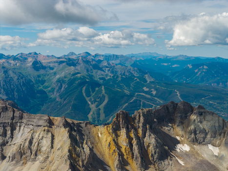 Aerial view of Mount Sneffels and the rugged peaks of the San Juan Mountain Range in the Rocky Mountains featuring dramatic rock formations and steep slopes Ouray Colorado United States. Aerial view of Mount Sneffels and the rugged peaks of the San Juan Mountain Range in the Rocky Mountains featuring dramatic rock formations and steep slopes Ouray Colorado United States.