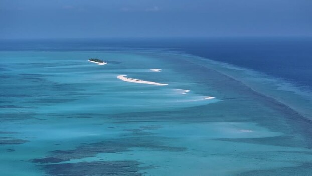 Aerial view of tropical sandbars and turquoise waters in the Maldives. Aerial view of tropical sandbars and turquoise waters in the Maldives.