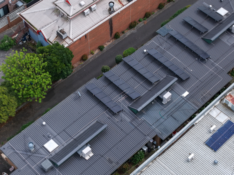 Melbourne VIC Australia 25 September 2026 Aerial view of industrial rooftops with solar panels and surrounding greenery.
