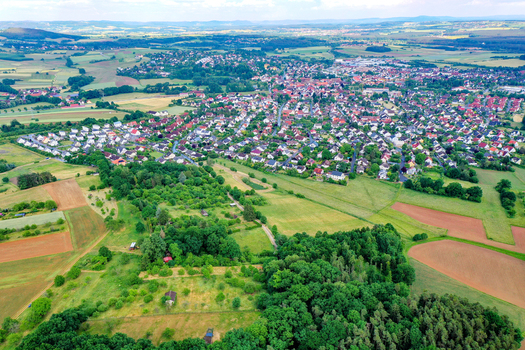 Aerial view of the town with its red roofed houses nestled among lush green fields and forests Neunkirchen am Brand Bavaria Germany. Aerial view of the town with its red roofed houses nestled among lush green fields and forests Neunkirchen am Brand Bavaria Germany.