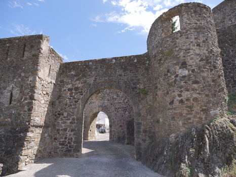 View of the historic stone archway and fortifications of Marvao Castle under a clear blue sky in Marvao Portalegre District Portugal. View of the historic stone archway and fortifications of Marvao Castle under a clear blue sky in Marvao Portalegre District Portugal.