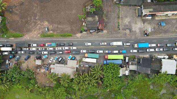 Aerial view of heavy traffic on the road near Merak in Pulomerak Banten Indonesia. Aerial view of heavy traffic on the road near Merak in Pulomerak Banten Indonesia.