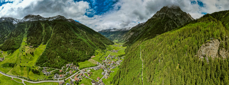 Aerial view of the village of Prutz nestled in the lush green valley of the Tyrol region surrounded by dense pine forests and towering alpine mountains in Prutz Tyrol Austria. Aerial view of the village of Prutz nestled in the lush green valley of the Tyrol region surrounded by dense pine forests and towering alpine mountains in Prutz Tyrol Austria.