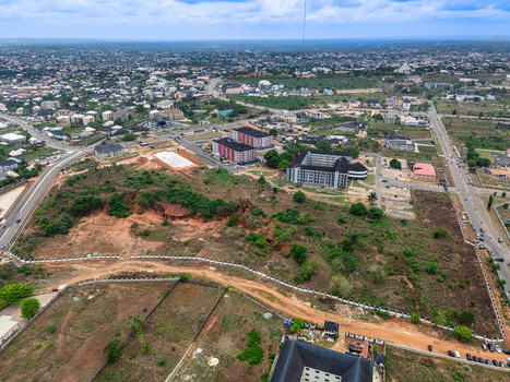 Aerial view of the landscape with patches of dense vegetation and modern buildings under a vast sky Umuahia Abia Nigeria. Aerial view of the landscape with patches of dense vegetation and modern buildings under a vast sky Umuahia Abia Nigeria.