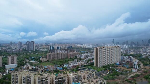 Aerial view of Gurugram skyscrapers under monsoon clouds India.