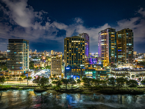 Aerial view of the illuminated Santo Domingo Malecon waterfront at night featuring high rise buildings palm trees and the Caribbean Sea Santo Domingo Distrito Nacional Dominican Republic. Aerial view of the illuminated Santo Domingo Malecon waterfront at night featuring high rise buildings palm trees and the Caribbean Sea Santo Domingo Distrito Nacional Dominican Republic.