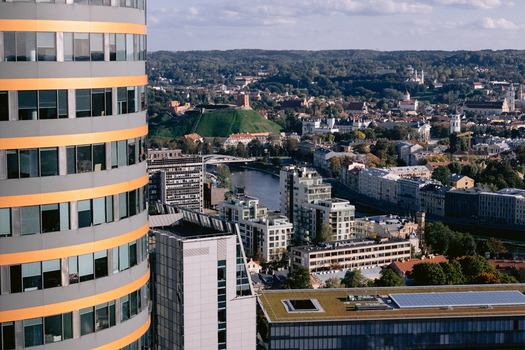 Aerial view of a modern skyscraper overlooking the cityscape of Vilnius featuring Gediminas Tower the Neris River and urban architecture in Vilnius Vilnius County Lithuania.