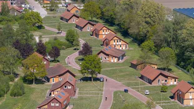 Drone view of AZC Luttelgeest in the Netherlands showing a reception centre for asylum seekers temporary housing community facilities and social infrastructure. Drone view of AZC Luttelgeest in the Netherlands showing a reception centre for asylum seekers temporary housing community facilities and social infrastructure.
