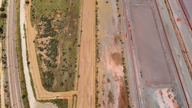 Aerial view of rusty red earth and linear drainage patterns create an abstract canvas of industrial tones and textures Africa. Aerial view of rusty red earth and linear drainage patterns create an abstract canvas of industrial tones and textures Africa.