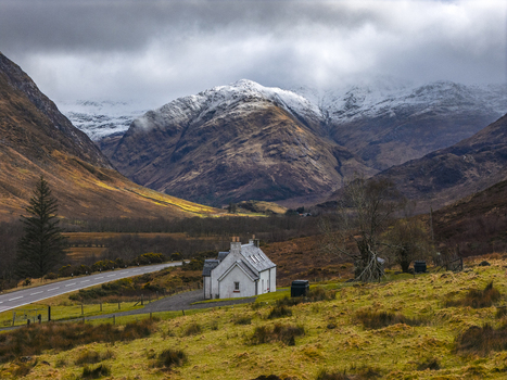 Aerial view of the historic Lagangarbh Hut in a dramatic valley surrounded by snow capped mountains and rugged terrain in Scotland United Kingdom. Aerial view of the historic Lagangarbh Hut in a dramatic valley surrounded by snow capped mountains and rugged terrain in Scotland United Kingdom.