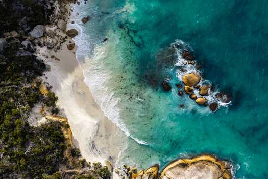 Aerial view of the turquoise waters and sandy beach at Two Peoples Bay Nature Reserve with granite boulders and coastal vegetation in Albany Western Australia Australia.