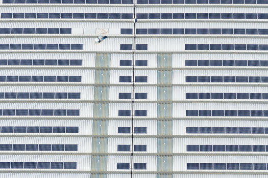 Aerial view of a large industrial building roof covered with rows of solar panels in Arezzo Tuscany Italy. Aerial view of a large industrial building roof covered with rows of solar panels in Arezzo Tuscany Italy.