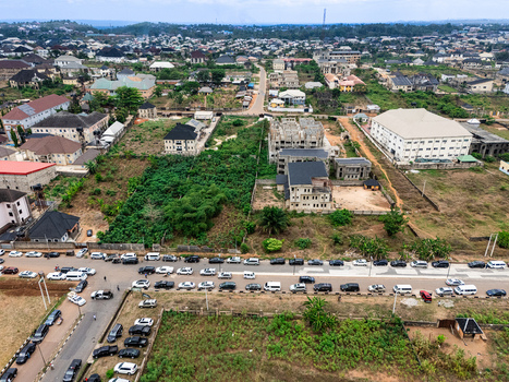 Aerial view of the bustling Ihie Ndume intersection with a line of cars contrasting against the backdrop of buildings and greenery Umuahia Abia Nigeria. Aerial view of the bustling Ihie Ndume intersection with a line of cars contrasting against the backdrop of buildings and greenery Umuahia Abia Nigeria.