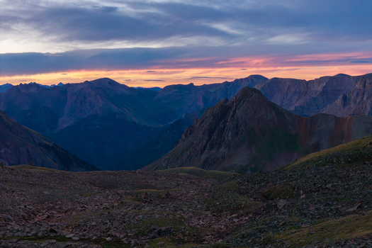 Aerial view of Mount Sneffels and the rugged peaks of the San Juan Mountain Range at sunset with rocky alpine terrain in Ouray Colorado United States. Aerial view of Mount Sneffels and the rugged peaks of the San Juan Mountain Range at sunset with rocky alpine terrain in Ouray Colorado United States.