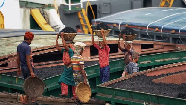 View of workers carrying coal baskets at Aminbazar Bangladesh. View of workers carrying coal baskets at Aminbazar Bangladesh.