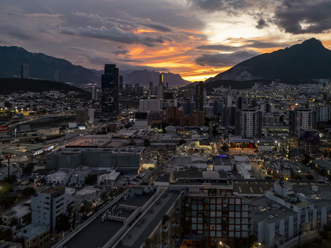 Aerial view of the Monterrey skyline at sunset with dramatic clouds over the mountains modern skyscrapers and urban infrastructure in Monterrey Nuevo Leon Mexico. Aerial view of the Monterrey skyline at sunset with dramatic clouds over the mountains modern skyscrapers and urban infrastructure in Monterrey Nuevo Leon Mexico.