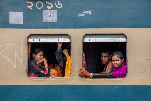 Dhaka Bangladesh 14 June 2018 View of passengers looking out of the windows of a crowded train at Airport Railway Station. Dhaka Bangladesh 14 June 2018 View of passengers looking out of the windows of a crowded train at Airport Railway Station.